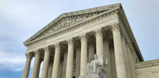 United States Supreme Court building with columns and statue