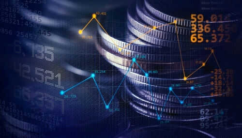 Stacked coins with financial data overlay graphs