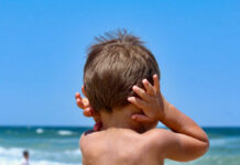 Navy Jet Roar Triggers Safety Probe child with hands on ears facing the ocean