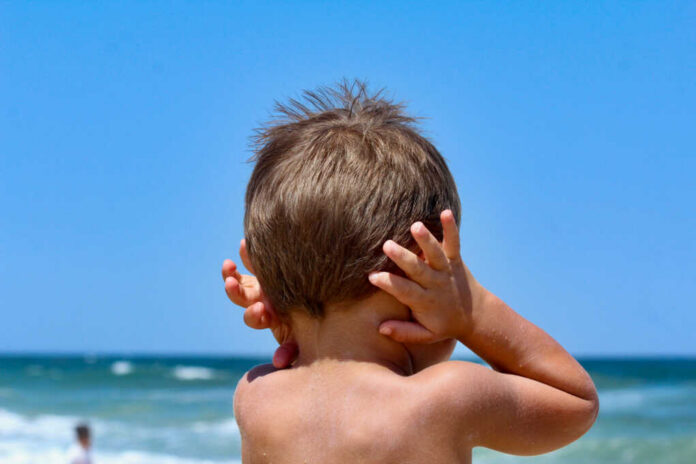 boy-covering-his-ears1686959827jpg child with hands on ears facing the ocean