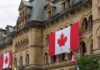 NATO Shock: Canada’s Military Hollowed Out Historic building with large Canadian flags displayed outside