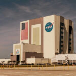 NASA Spin Hides Artemis Glitches NASAs Vehicle Assembly Building with Artemis sign.