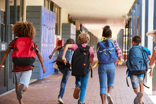school735954742jpg Children with backpacks running in a school corridor
