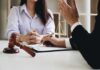 Two people in a legal consultation at a desk