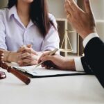 Corporate Confess-And-Walk? DOJ’s Bold Shift Two people in a legal consultation at a desk
