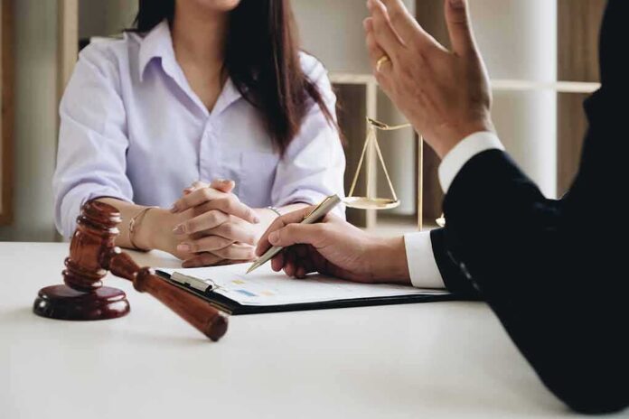 shutterstock_1067138630 Two people in a legal consultation at a desk