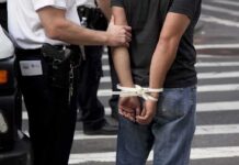 Anti-ICE Rampage Backfires—Immigrant Hurt police officer detains person with hands zip-tied behind back