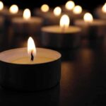 Nippon Paper Disaster — Toll Keeps Climbing Tealight candle burning with soft glow