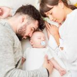 Benefit Cliffs Crush Two-Parent Homes Parents sleeping beside newborn baby