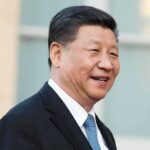 Beijing’s Ban Rattles NATO Supply Chains man in suit smiling outdoors