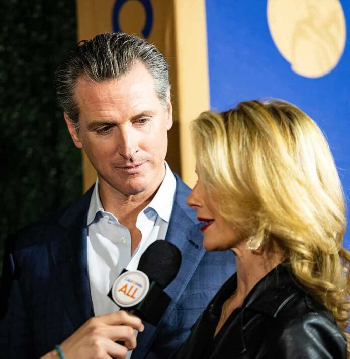 shutterstock_1585339564 man in suit listening as woman speaks into a microphone