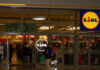 Air-Con Stampede Shocks France Entrance of a Lidl grocery store with customers shopping