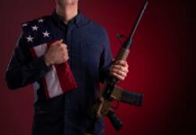 Veteran Firebrand Torches Gun-Free Myths Speaker at podium raising a fist during a conference