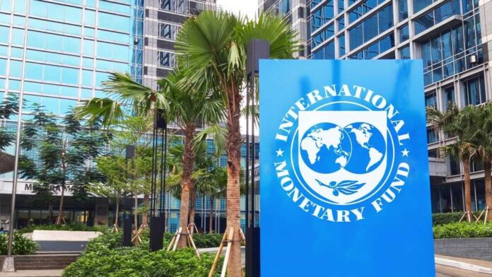 Jakarta,-,May,02,2024:,International,Monetary,Fund,(,Imf),Logo Sign of the International Monetary Fund in front of a modern building with palm trees