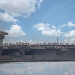 Aircraft carrier sailing with jets on deck
