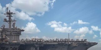 Aircraft carrier sailing with jets on deck