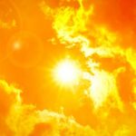 Thermometer displaying high temperature against a sunset city skyline
