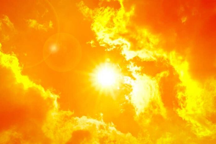 Orange,Sky,With,Sun,And,Clouds,During,Hot,Summer,Weather Thermometer displaying high temperature against a sunset city skyline