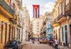 Cuban flag over colorful old Havana street