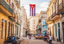 Cuban flag over colorful old Havana street