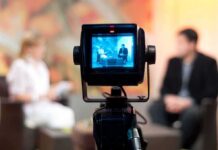 Prime-Time Exploitation? MPs Demand Answers Television camera filming an interview set