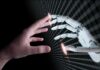 AI PAC Machine Crushes Dissent Human hand reaching toward a robotic hand