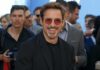 smiling man in sunglasses at a public event