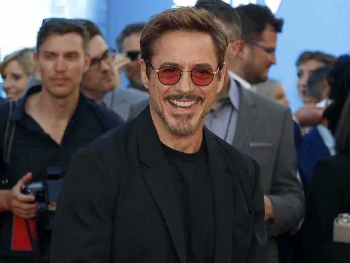 smiling man in sunglasses at a public event