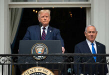 Two men standing at a podium outdoors