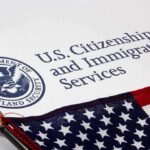 Citizenship Crackdown Explodes — Who’s Next? U.S. Citizenship and Immigration Services document with American flag