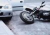 Motorcycle Mayhem on I‑76 — Lane-Splitting Fight Erupts Motorcycle lying on the street beside a car with an open door