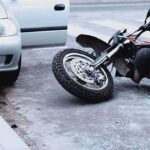 Motorcycle Mayhem on I‑76 — Lane-Splitting Fight Erupts Motorcycle lying on the street beside a car with an open door