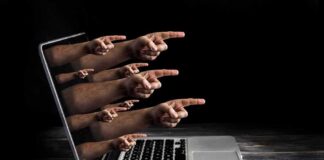 Laptop with multiple hands pointing from the screen