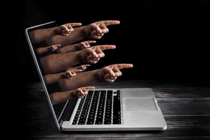 shutterstock_1061278154 Laptop with multiple hands pointing from the screen