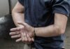 person in handcuffs with hands behind back