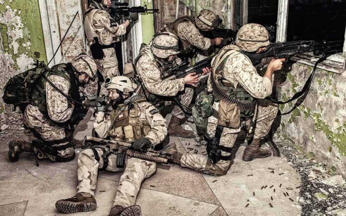 shutterstock_1163417059 soldiers in camouflage gear take positions inside a damaged building