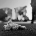 Postpartum Spiral, Prosecutors Push Intent Stuffed toy lying on pavement in black and white