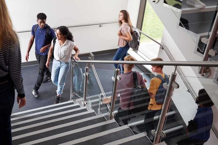 shutterstock_1188887332-1 Students walking on a school staircase
