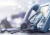 258 Nabbed in Call-Center Crackdown Headset resting on an office desk phone