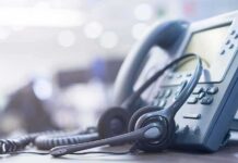 258 Nabbed in Call-Center Crackdown Headset resting on an office desk phone