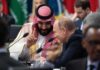 Petrodollar Play: Wall Street On Notice Two delegates converse at an international summit table