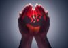 Hands cupping a glowing fetal silhouette