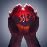 Hands cupping a glowing fetal silhouette