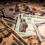 United States Treasury check on a pile of US dollar bills