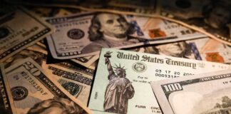 United States Treasury check on a pile of US dollar bills