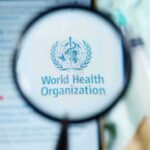 Bundibugyo Outbreak Escalates — Containment Falters Magnifying glass over WHO logo on smartphone screen