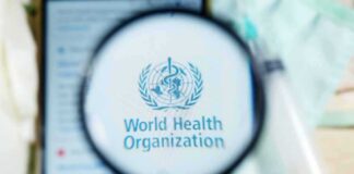 Magnifying glass over WHO logo on smartphone screen