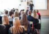 Campus Shock: Tenure Hinges on Ideology Students seated in a classroom listening to a presentation