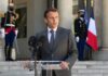 Tone-Deaf Jet Ski Photo Engulfs Macron man in suit speaking at podium with microphones