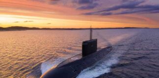Submarine cruising on the surface at sunset